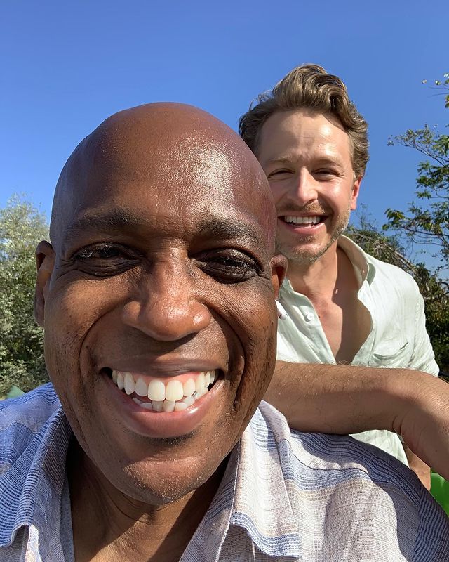 Daryl Edwards smiling in a light blue lined shirt.